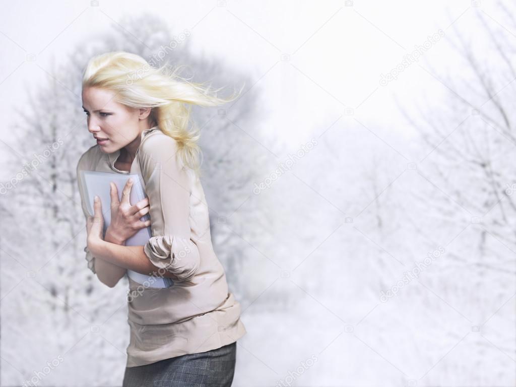 Woman with hair blowing facing into wind