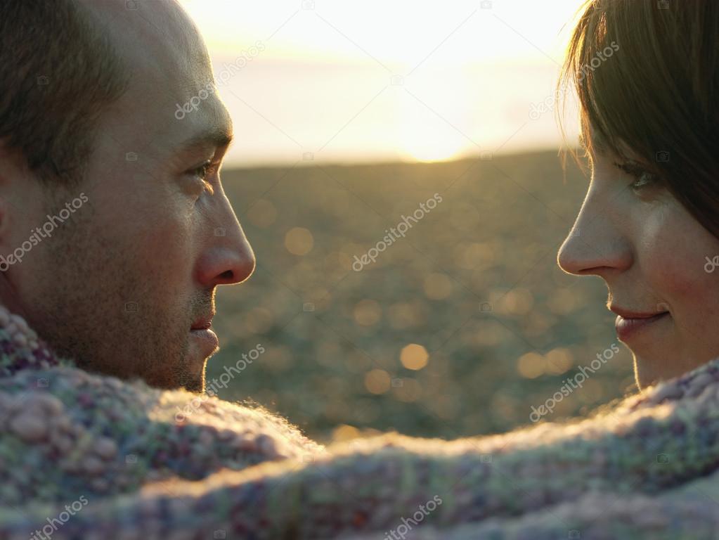 Couple wrapped in blanket