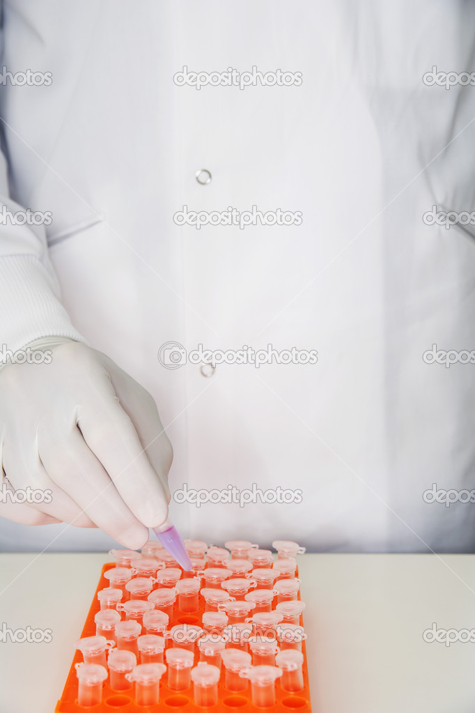 Lab worker with test tubes