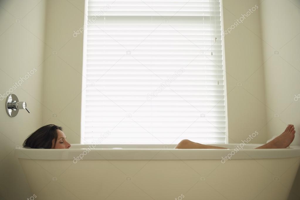 Woman lying in bath