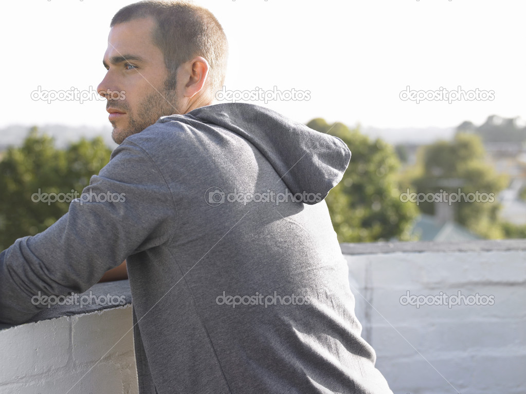 Man looking over balcony