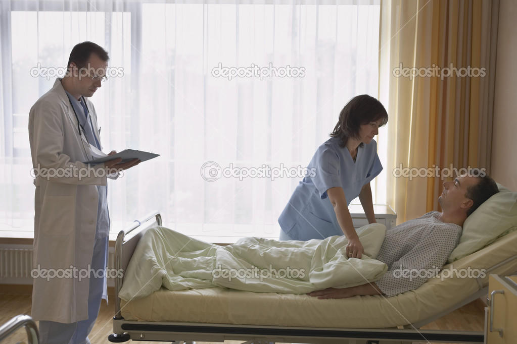 Nurse with doctor adjusting patient