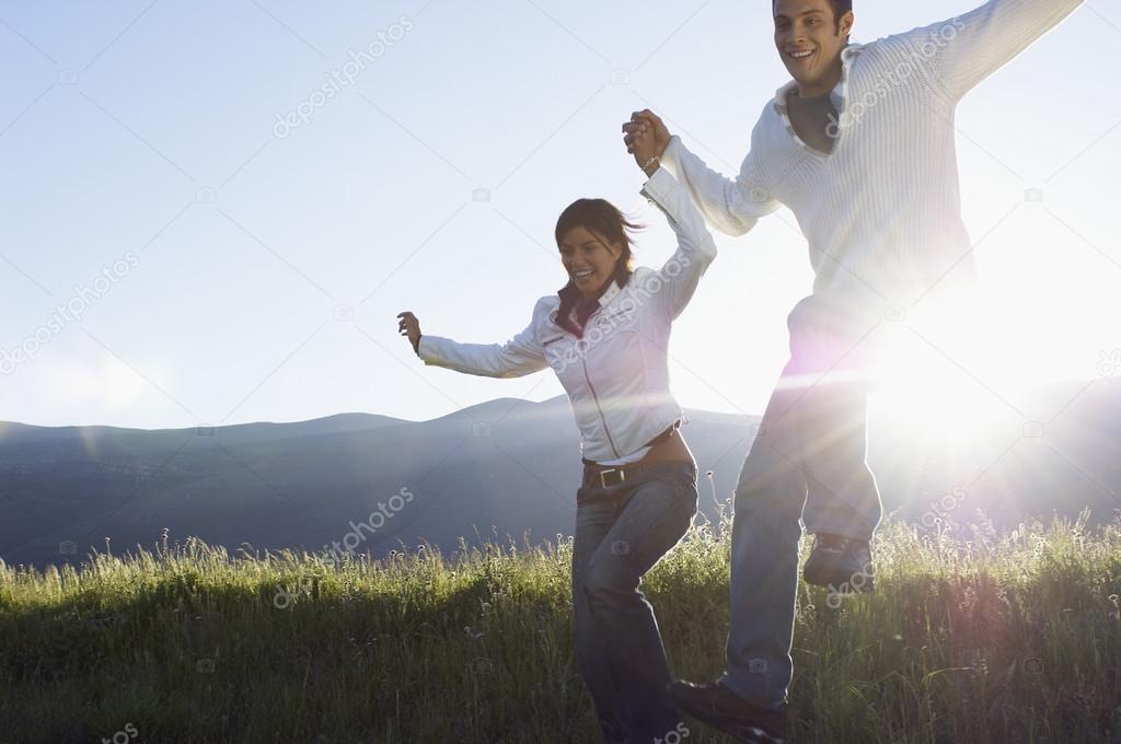 Couple running and jumping