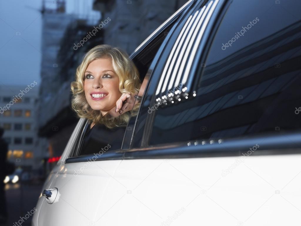 Woman in back of limousine