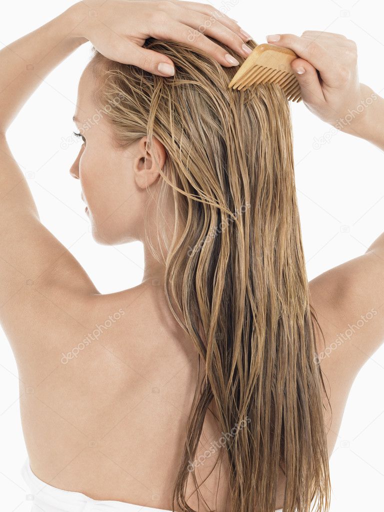 Young Blond Woman Combing Hair