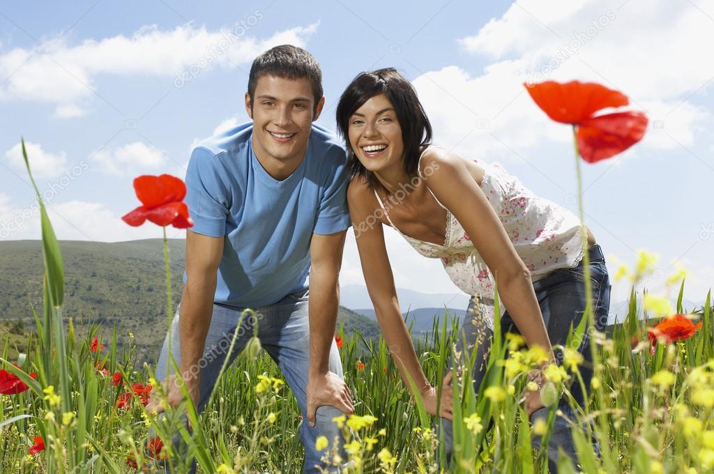 Couple standing in meadow
