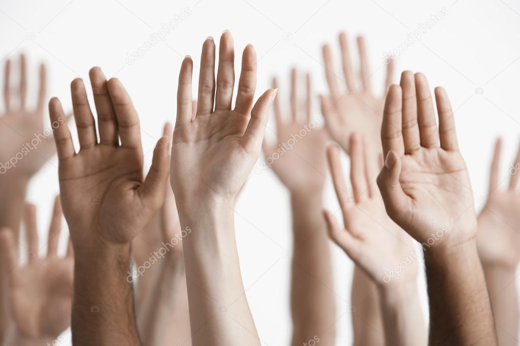 Men and women raising hands