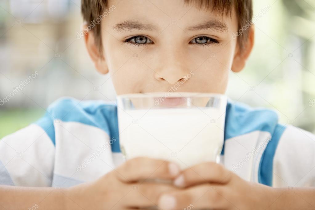 boy holding glass of milk 