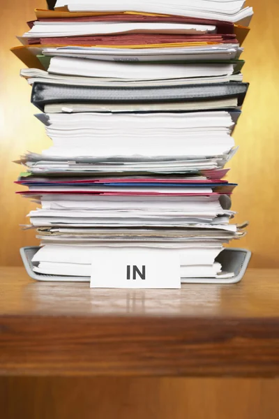 Inbox with stack of paperwork — Stock Photo, Image