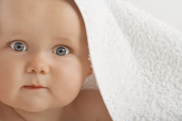 Baby with wearing towel over head — Stock Photo, Image