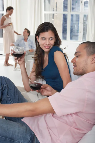 Paare trinken Wein im Wohnzimmer — Stockfoto