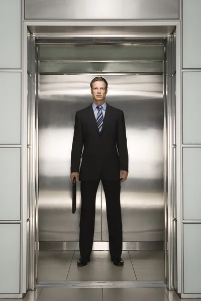 Businessman standing in Elevator — Stock Photo, Image