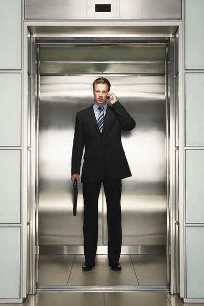 Businessman with Cell Phone on Elevator — Stock Photo, Image