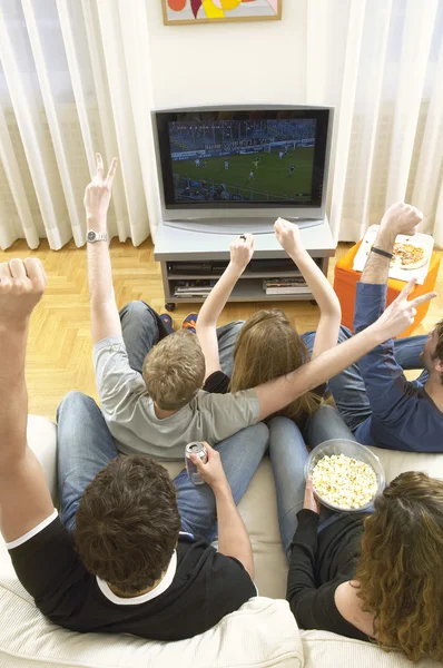 Amigos assistindo TV e comemorando — Fotografia de Stock