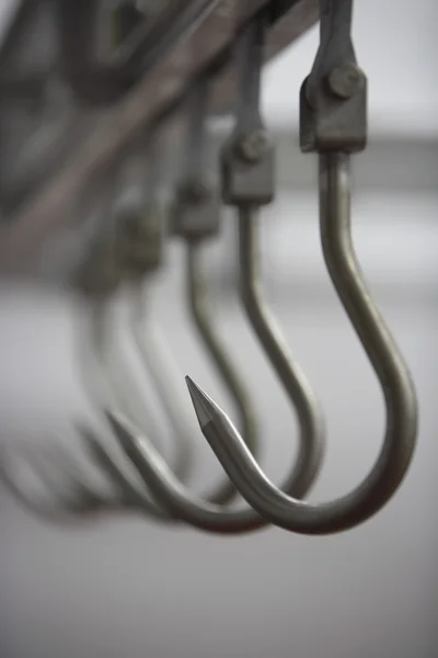 Meat Hooks in a row — Stock Photo, Image