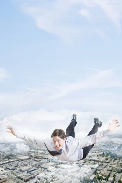 Businessman flying over city — Stock Photo, Image