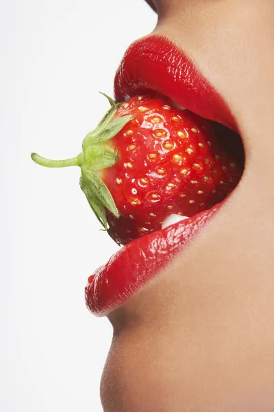 Frau beißt in Erdbeere — Stockfoto