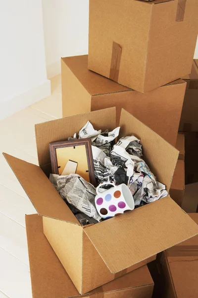 Open box newspaper and cup inside — Stock Photo, Image