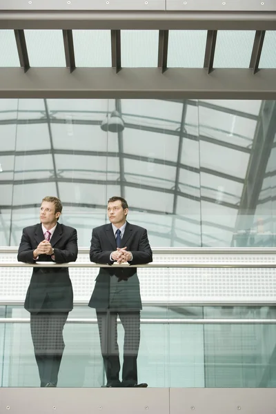 Businessmen Leaning at Railing — Stock Photo, Image