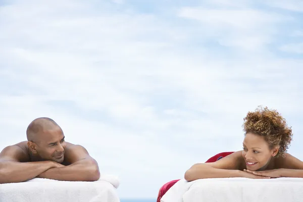 Par liggande på massagebänkar — Stockfoto