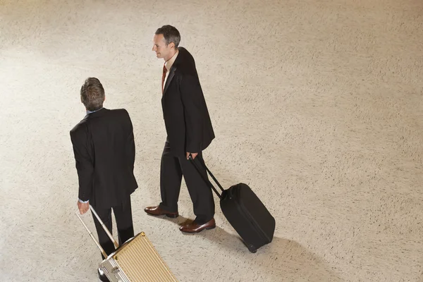 Business men pulling suitcases — Stock Photo, Image