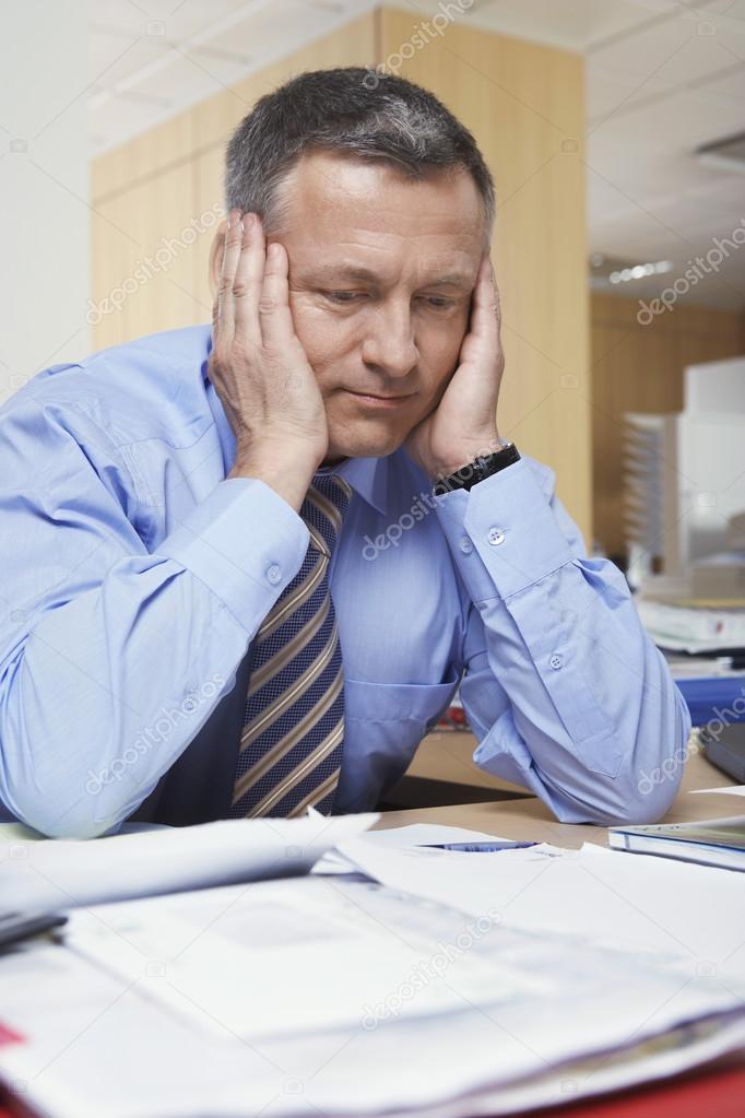 Businessman with head in hands