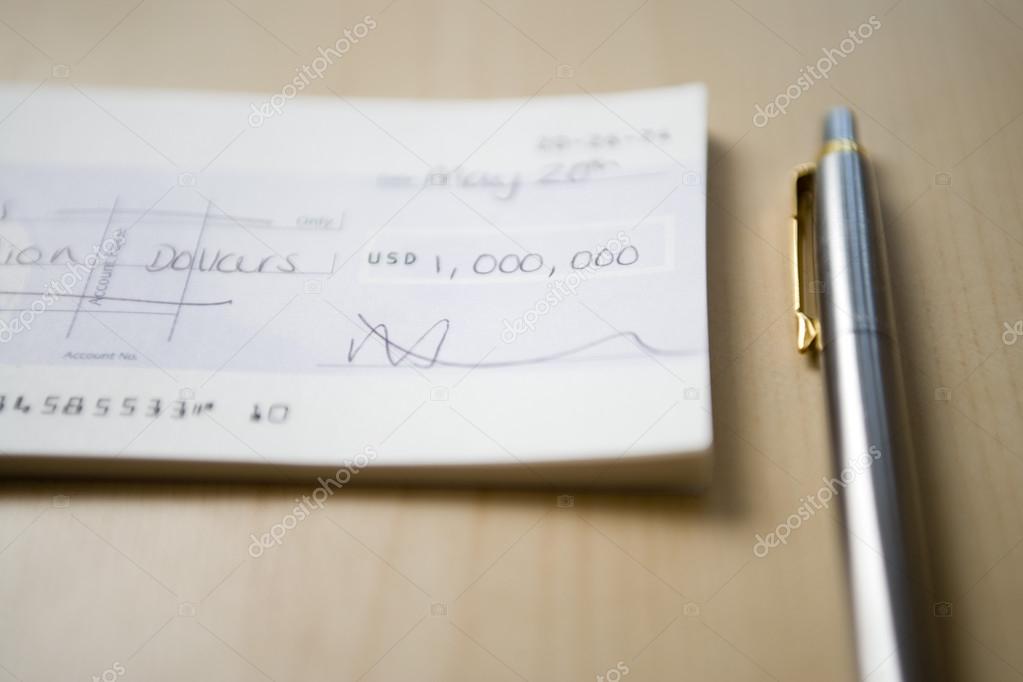 Cheque lying next to pen