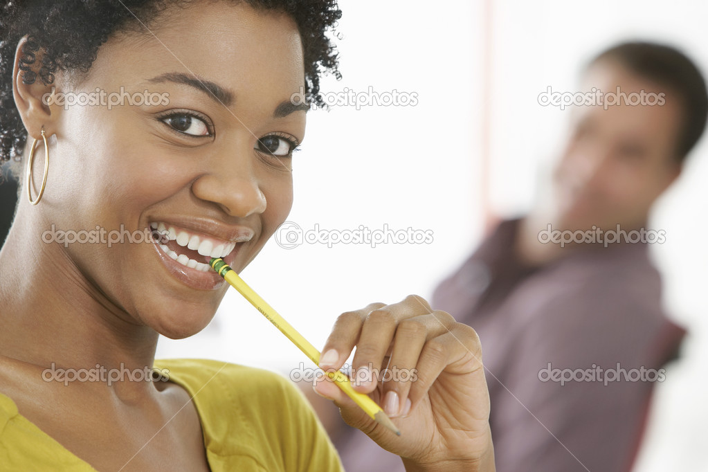 Businesswoman chewing pencil