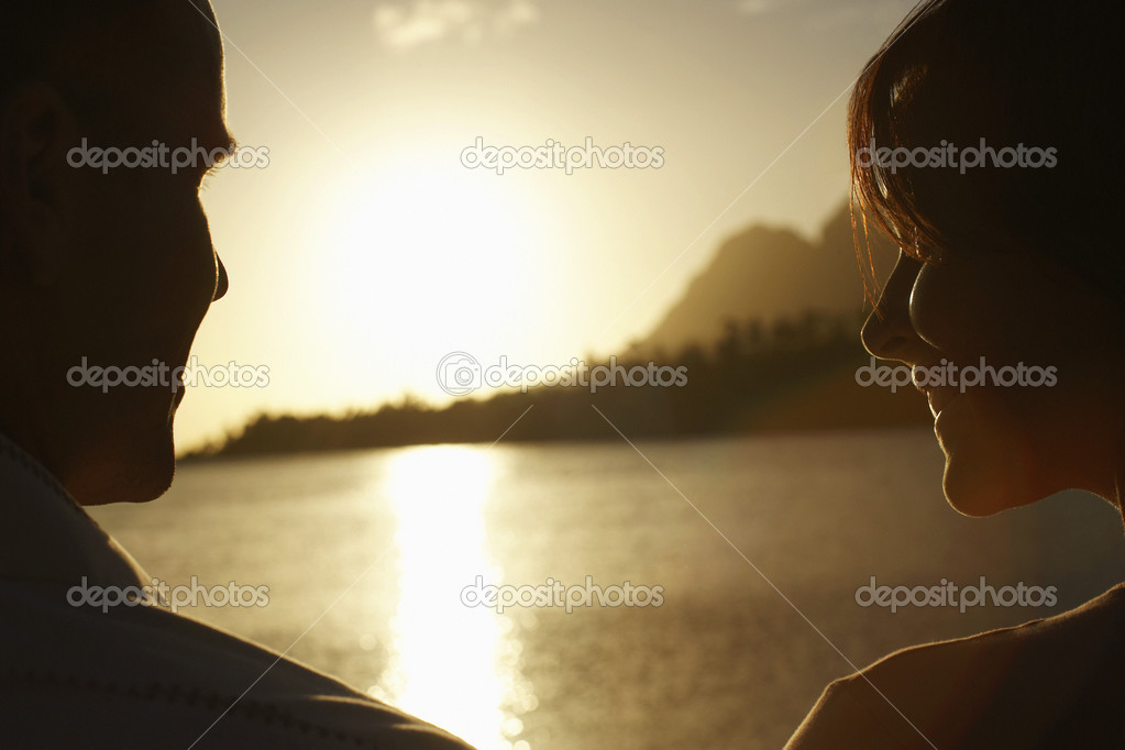 Couple Watching Sunset over Lake