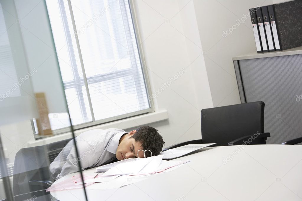 Businessman asleep at desk