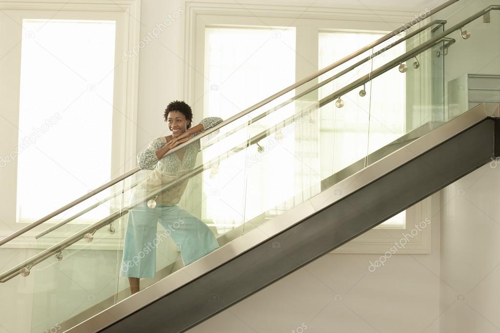 Woman standing on glass stairs