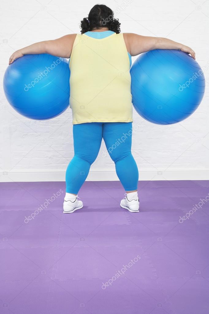 Woman Holding Exercise Balls