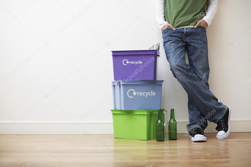 Man next to recyling containers