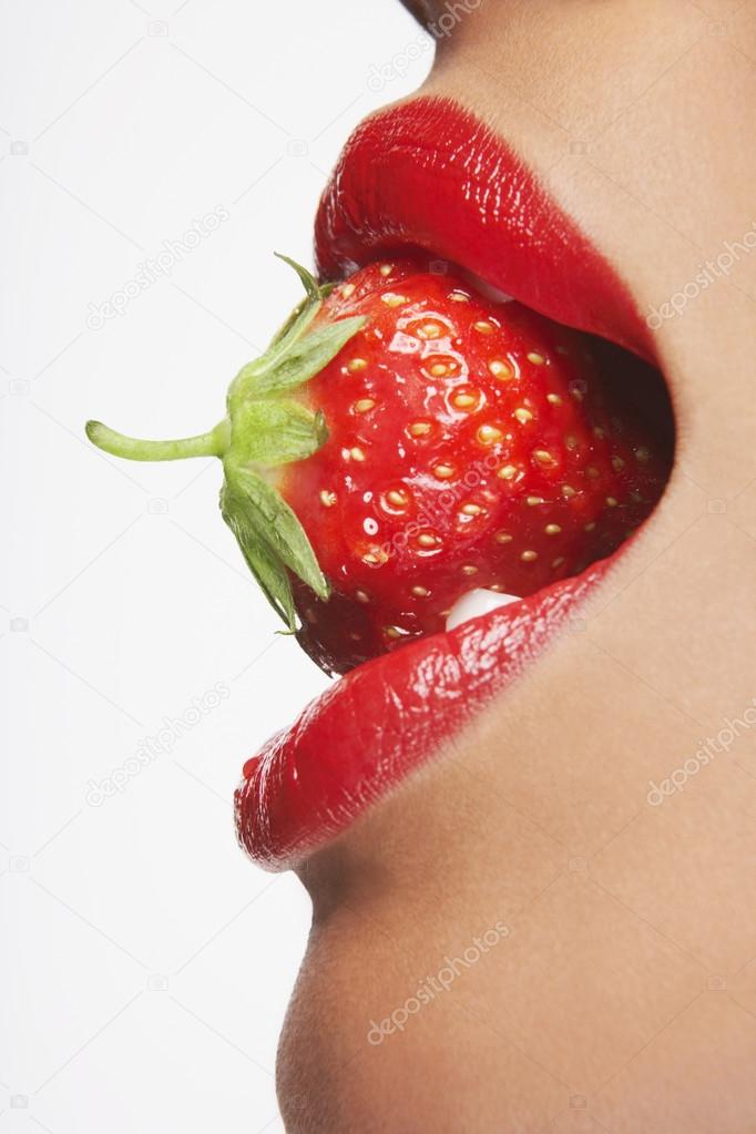 Woman Biting Strawberry