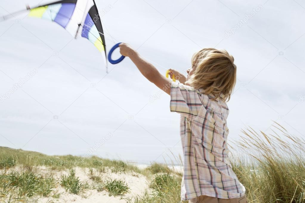  little boy with flying kite 