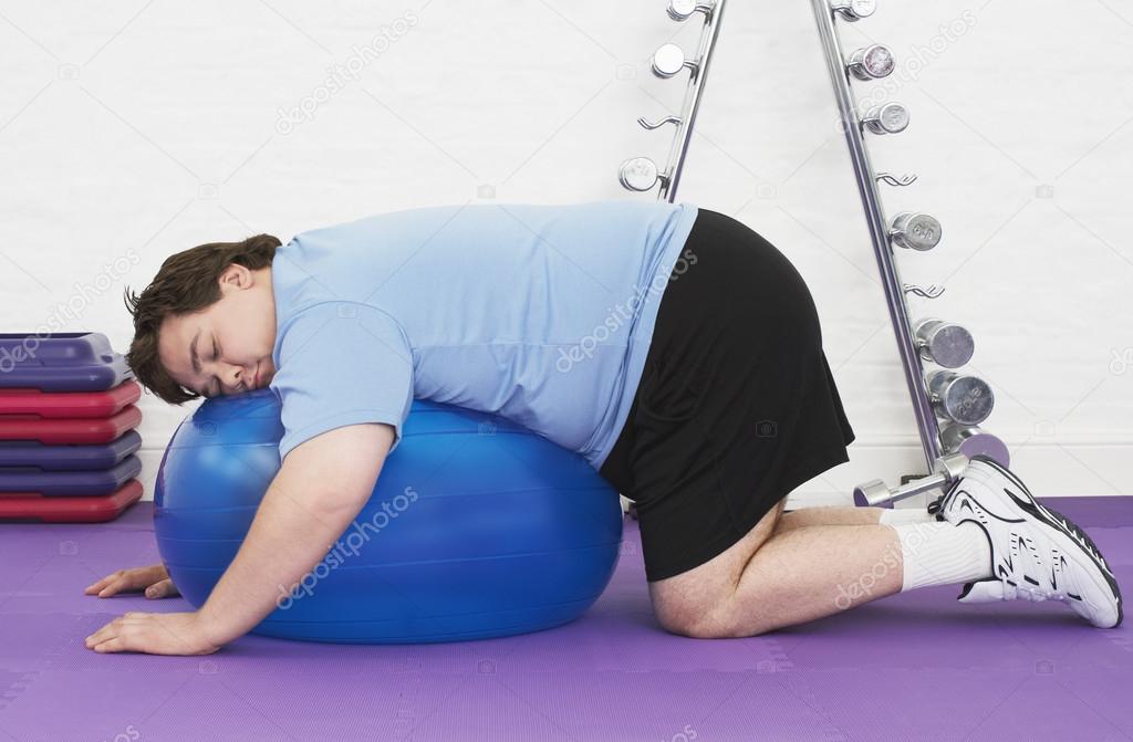 Man sleeping on Exercise Ball