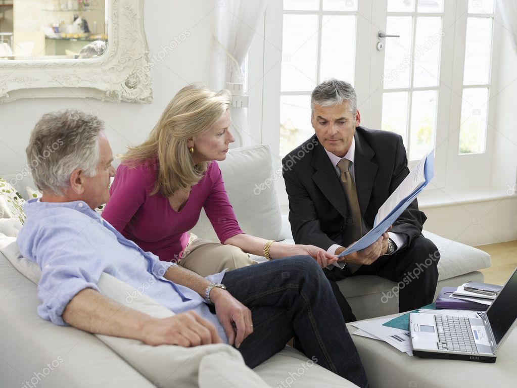 Couple sitting on sofa with financial advisor