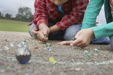 Boy and Girl Playing Marbles clipart