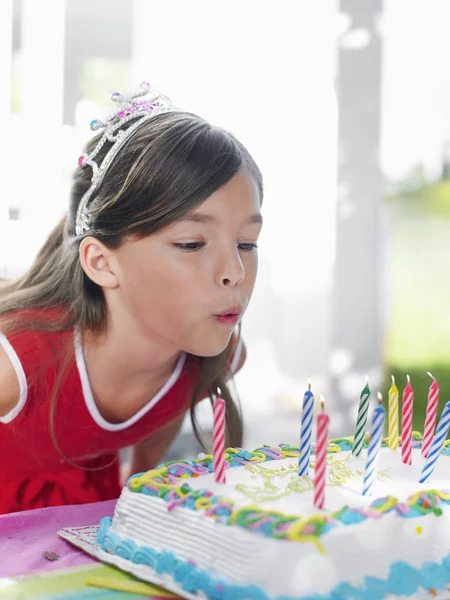 Girl blowing out candles — Stock Photo, Image
