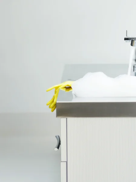 Rubber gloves on sink — Stock Photo, Image