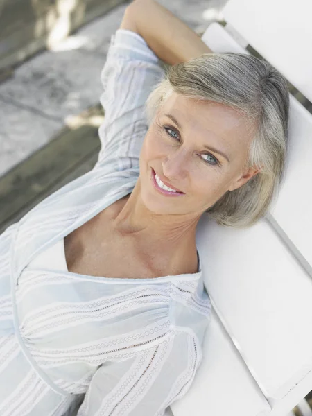 Woman reclining on sun lounger — Stock Photo, Image