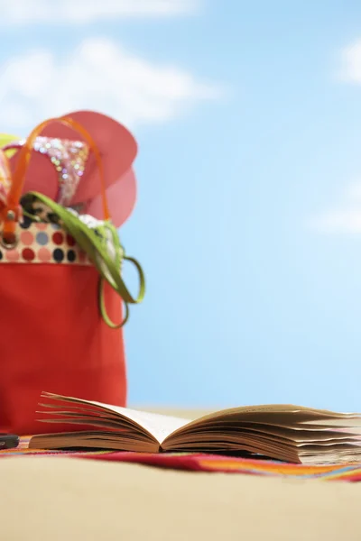 Book next to beach bag — Stock Photo, Image