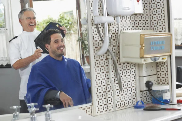 Barber showing  hair — Stock Photo, Image
