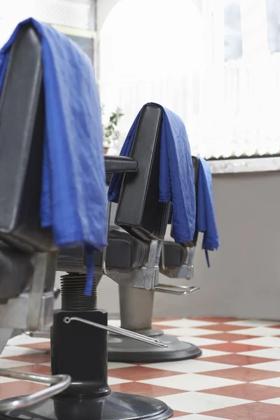 Capes on barbers chairs — Stock Photo, Image