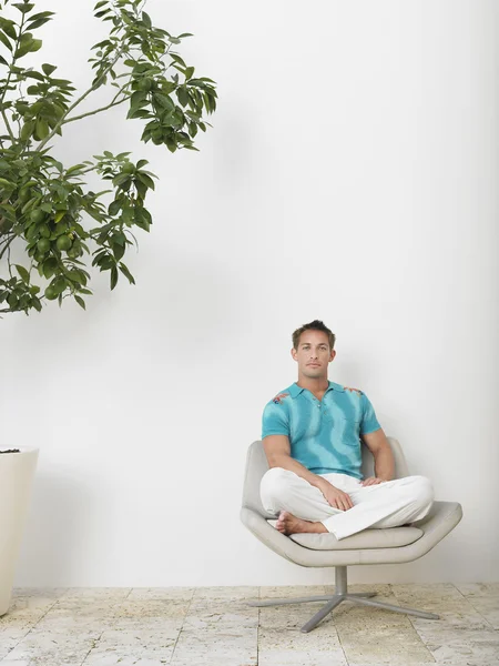 Man Sitting in Swivel Chair — Stock Photo, Image