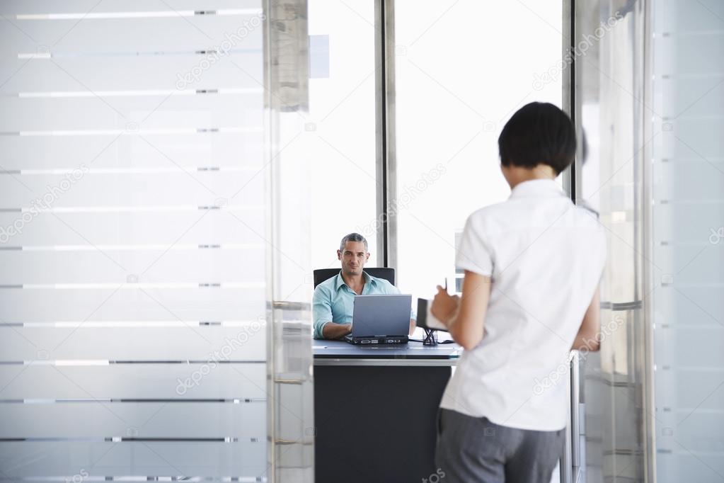 Businessman and Businesswoman in Office
