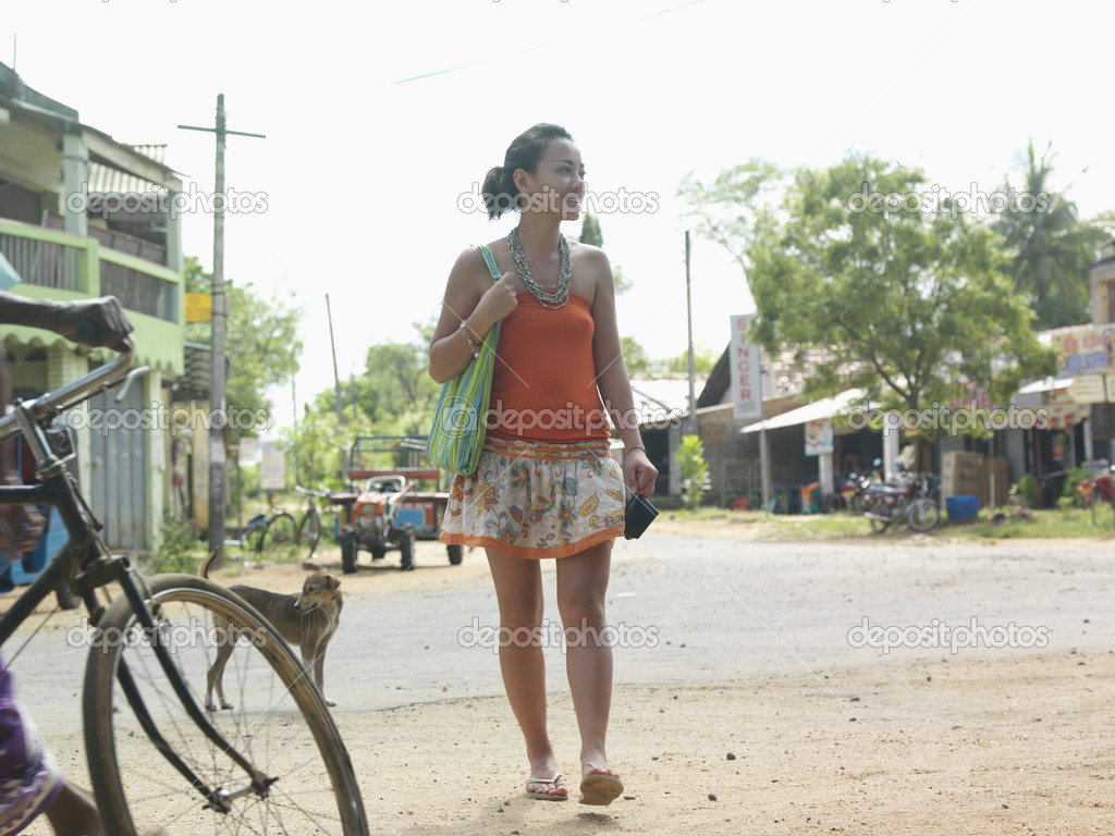 Woman walking on rural road