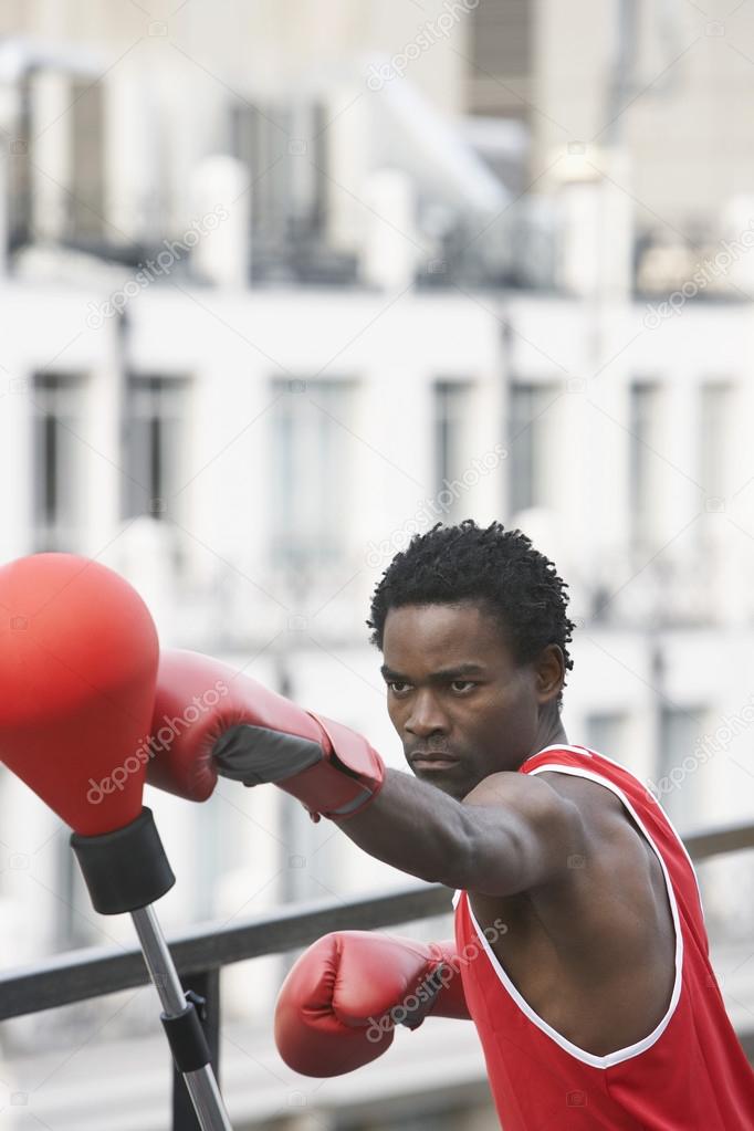 Boxer Hitting Punching Bag — Stock Photo © londondeposit 33862703