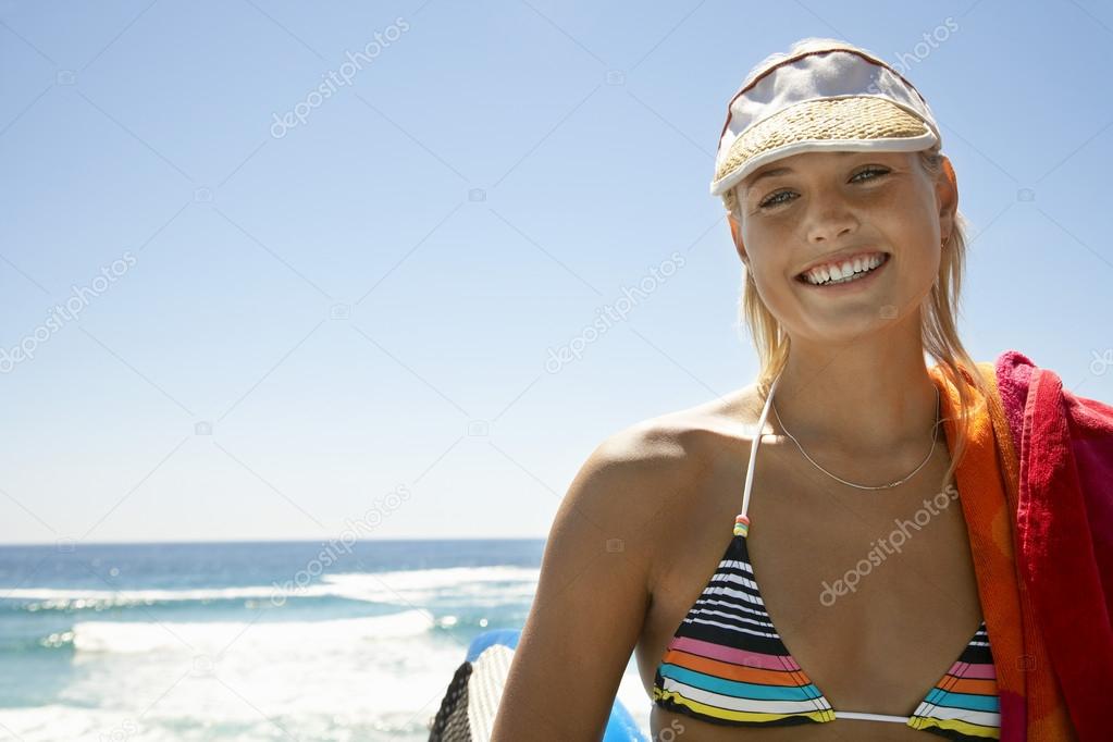 Woman in sun visor smiling