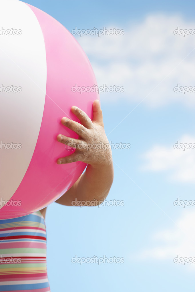 little Girl hand holding beach ball 